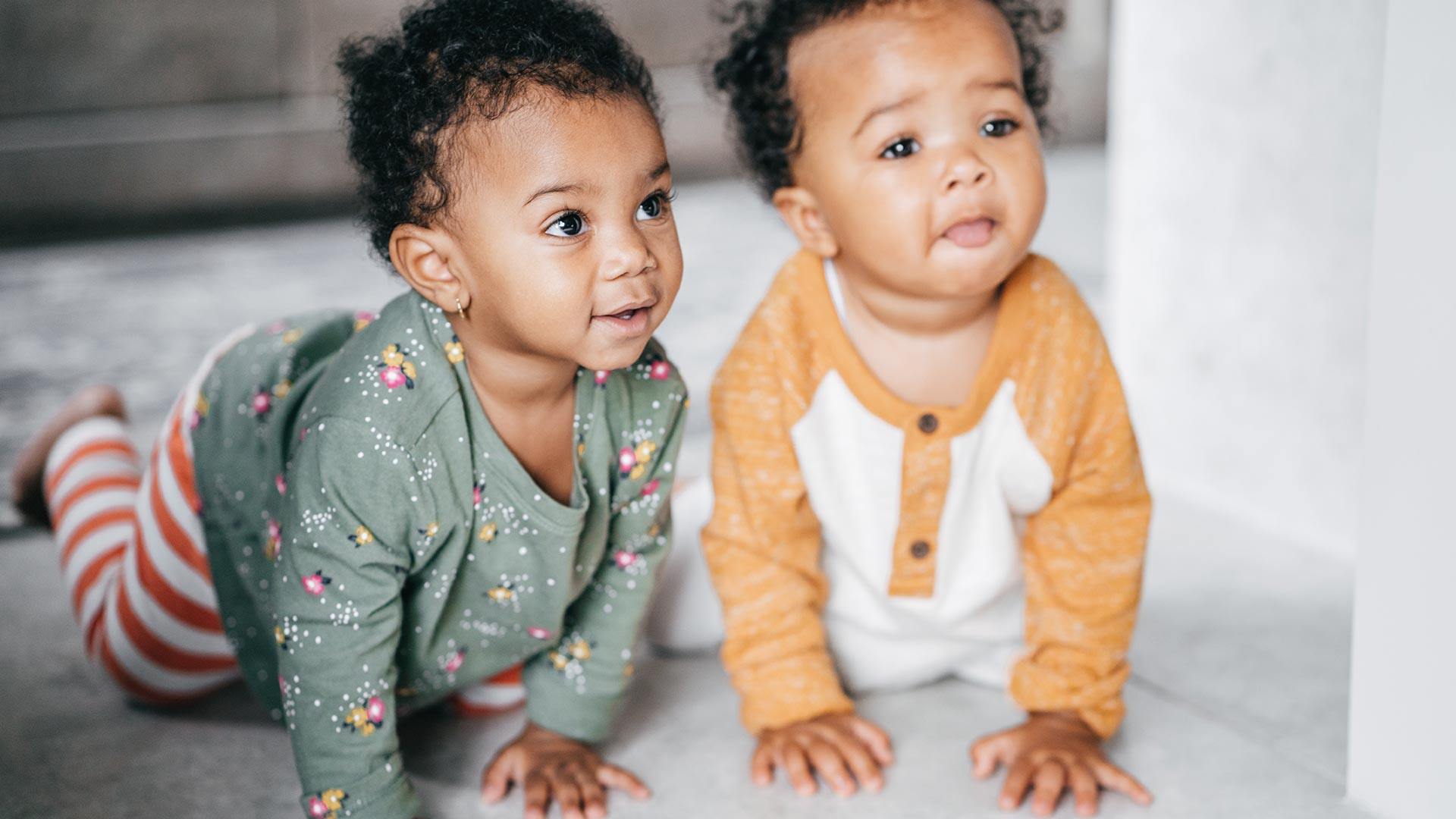 Two mixed babies crawling