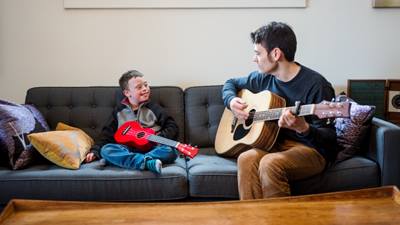 Male music therapist and patient playing guitar
