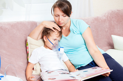 Mom Reading to Son During Asthma Treatment